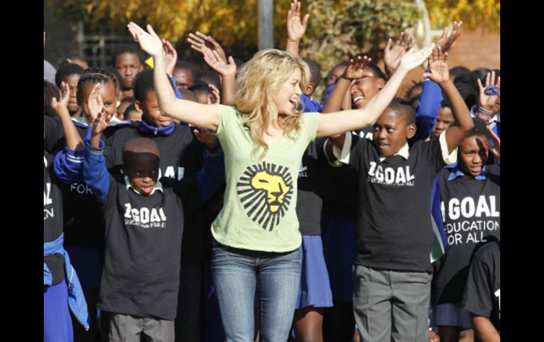 Shakira, la interprete del tema ''Waka Waka'' en Johannesburgo con un grupo de niños. AP  /