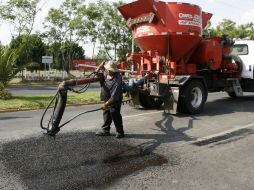 Una cuadrilla realiza labores de bacheo sobre la Avenida Parres Arias, una de las principales de Zapopan. M. FREYRÍA  /