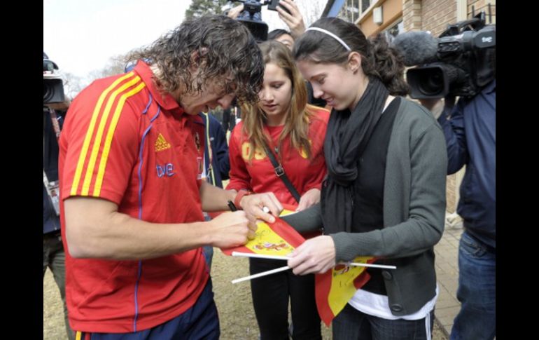 Carles Puyol dando autógrafo a sus aficionados. AFP  /