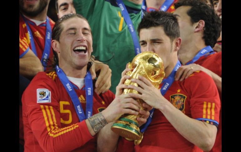 David Villa (der.) besa el trofeo junto al defensa Sergio Ramos. AFP  /