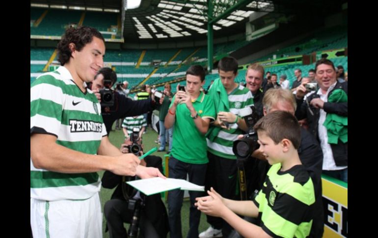 Efraín Juárez firmando autógrafos a los fanáticos. AP  /