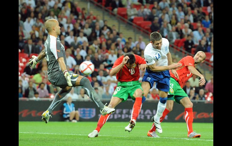 El inglés Gary Cahill (2-der) disputa el balón con los búlgaros Zhivko Milanov (2-iz) e Illiyan Stoyanov en el partido. EFE  /