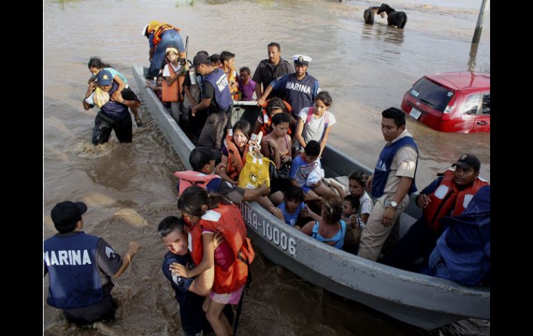 Miembros de la Marina auxilian hoy a varias personas, tras las recientes inundaciones en Boca del Río, Veracruz. EFE  /