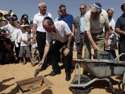 El vice primer ministro israelí, Silvan Shalom, fija la primera piedra para una escuela en Naveh. AP  /