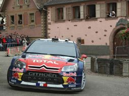 Sébastien Loeb, a bordo de su Citroën C4, pasa por la compañía francesa de su natal Alsacia, en Heiligenstein. AP  /