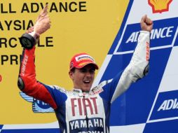 El piloto español celebra en el podio su victoria. AFP  /