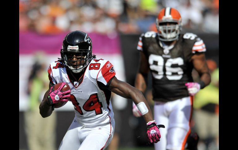 El  receptor Roddy White de los  Halcones de Atlanta (84) se adelanta a la defensiva de Cleveland. AP  /