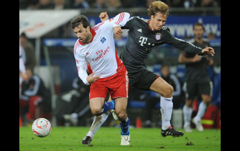 El jugador del Hamburgo, Ruud van Nistelrooy (iz), disputa el balón con Andreas Ottl (der), del Bayern Munich. EFE  /