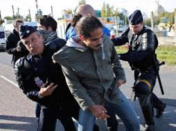 Policías arrestan a un huelguista que bloqueaba una refinería, en el Este de París. AP  /