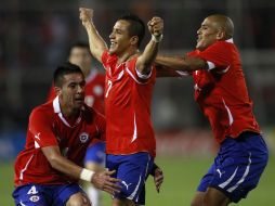 Alexis Sanchez celebra con sus compañeros Mauricio Isla y Humberto Suazo el gol anotado a Uruguay. AP  /