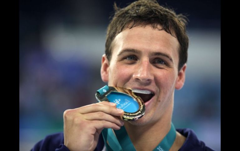 El nadador estadounidense Ryan Lochte posa con su nueva medalla de oro. AFP  /