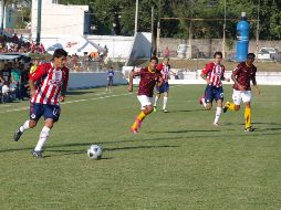 Mitchel Oviedo, de Chivas, lleva un balón, ante la mirada de sus compañeros y jugadores de Tecos. ESPECIAL  /