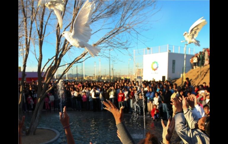 Cientos de personas lanzan al aire palomas blancas en recuerdo de los jóvenes asesinados en Salvárcar, en Ciudad Juárez. AFP  /