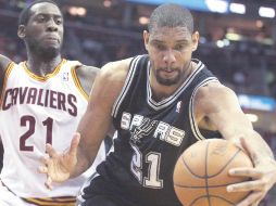 Tim Duncan (negro) de San Antonio, recupera  un balón ante J.J. Hickson. REUTERS  /