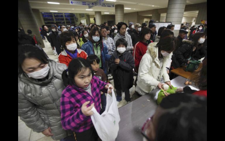 Imágenes de un centro de refugio para evacuados de Fukushima, el índice de radiación de las personas es medido a su ingreso. AP  /