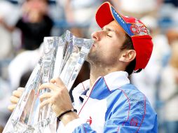 Novak Djokovic, quien besa el trofeo que ganó ayer en Indian Wells, California, conquistó su tercer título de 2011. AFP  /