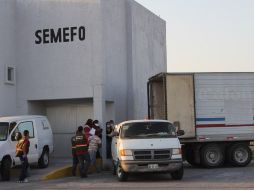 Peritos forenses descargan los restos de cadáveres hallados. Autoridades estatales y federales apoyarán en la identificación. AFP  /