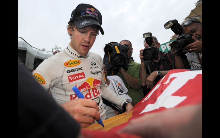 El piloto alemán Sebastian Vettel, de la Escudería Red Bull, firma autógrafos tras su victoria en Malasia. AFP  /