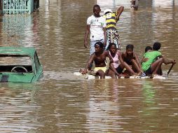 Residentes colombianos navegan por una calle inundada en Cali. REUTERS  /