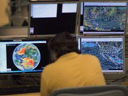 Un meteorólogo del Centro Nacional de Huracanes en Miami sigue la actividad de 'Arlene' en el Atlántico. AFP  /