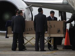 Personal de funerarias y los empleados del aeropuerto de transporte del ataúd del cantante argentino. REUTERS  /