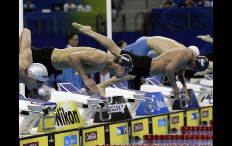 Michael Phelps ( segundo de la izquierda) y otros competidores se preparan para dar inicio a la semifinal. AP  /