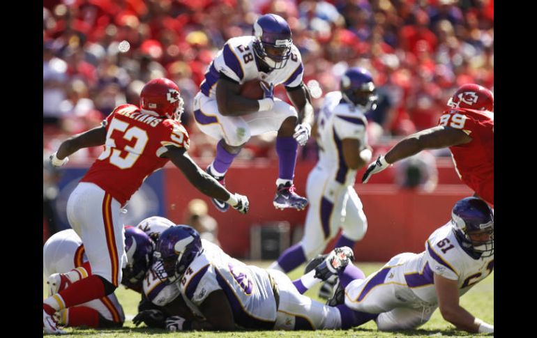 Adrian Peterson (28), Demorrio Williams (53) y Amon Gordon (99) durante la primera parte del encuentro entre Jefes y Vikingos. AP  /