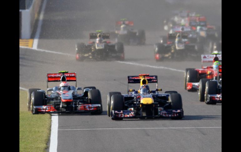 Polémica desde el arranque: Vettel y Button disputando la pista. AP  /