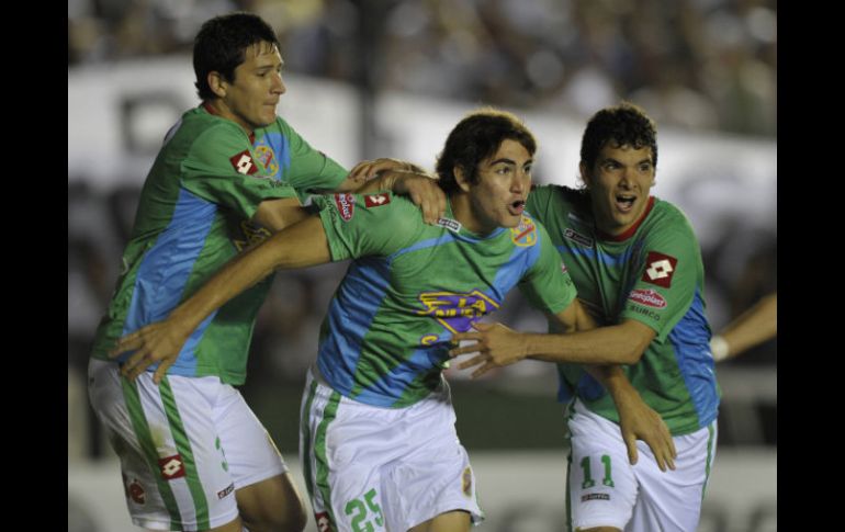 Gustavo Blanco (C) celebra junto con sus compañeros Guillermo Burdisso (I) y Emilio Zelaya el triunfo de su equipo. AFP  /