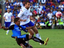 Manuel López Mondragon (I) de Querétaro aparta el balón del poder de Emanuel Villa de Cruz Azul. AFP  /