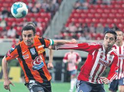 Leobardo López, del Pachuca, pelea por un esférico con Marco Fabián, de Chivas. EFE  /