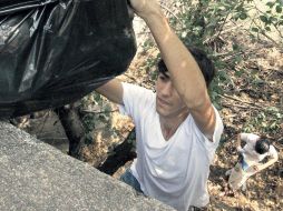 Uno de los voluntarios saca un costal que contiene desechos recolectados ayer en el Parque Mirador.  /