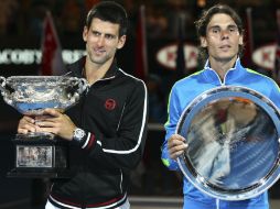 Djokovic (i) y Nadal (d) posan con sus respectivos trofeos tras terminar el partido de cinco horas y 53 minutos de duración. AP  /