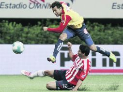 Miguel Sabah, héroe de Morelia y verdugo de Chivas, dispara a gol ante la marca de Jonny Magallón. MEXSPORT  /