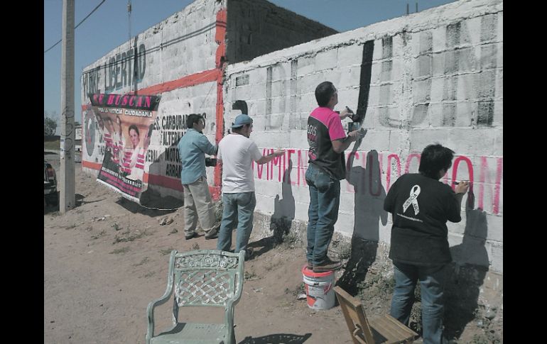 Integrantes y simpatizantes del Movimiento 5 de Junio colaboran con la pinta de bardas, en exigencia de justicia. ESPECIAL  /