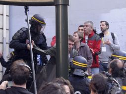 La Policía francesa interviene contra un manifestante que participa en la protesta contra el presidente francés. EFE  /