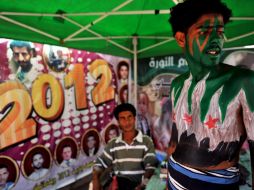 Un manifestante se pinta en Yemen los colores de la bandera siria en festejo del primer año de la revuelta. EFE  /