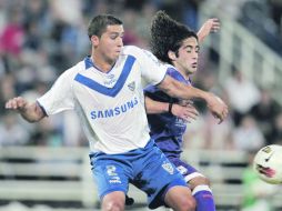 Fernando Tovio, del Vélez, disputa un balón con Matías Britos, del Sporting uruguayo. AP  /