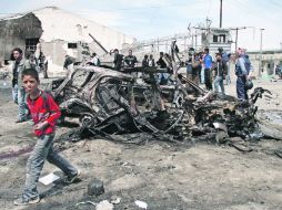 Un coche destruido en el lugar del ataque suicida talibán en Kabul, Afganistán, en respuesta a la visita de Barack Obama. EFE  /