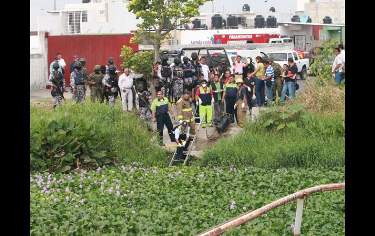 Forenses veracruzanos haciendo el levantamiento de los restos de los reporteros asesinados. EFE  /