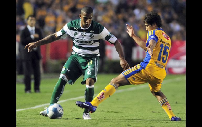 Acción del partido entre Tigres Y Santos, Suárez del Santos (izq) trata de quitarse la marca de Viniegra. EFE  /