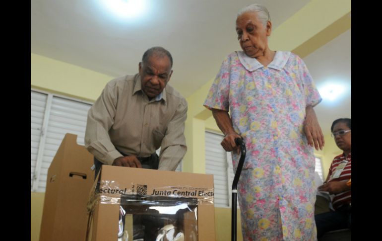 Un hombre ayuda a una mujer a votar durante las elecciones presidenciales. EFE  /