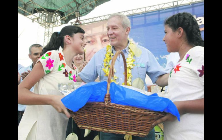 Dos niñas llevan un regalo al candidato panista, durante su mitin en la comunidad de Cuzalapa, municipio de Cuautitlán.ESPECIAL  /