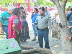 Un inspector discute con los vecinos ante un árbol cortado. ESPECIAL  /