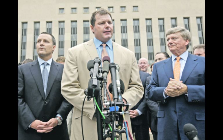 Roger Clemens habla con la prensa afuera de la corte, flanqueado por sus abogados. AP  /