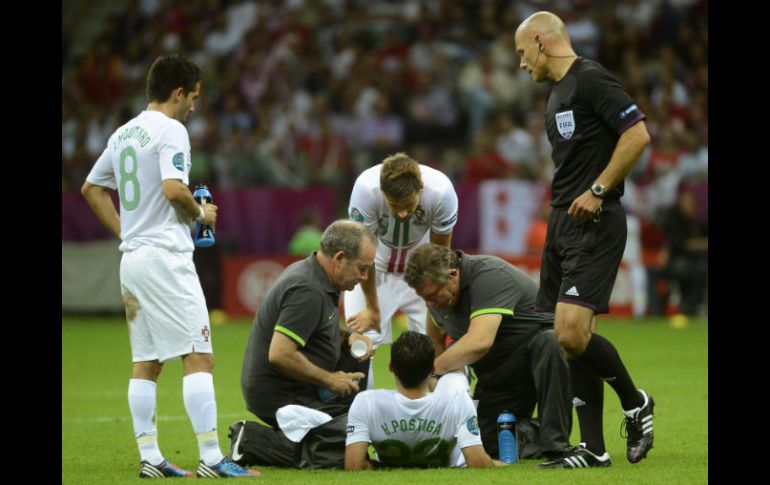 El portugués Helder Postiga (abajo) recibe tratamiento durante el partido de cuartos de final de la Eurocopa 2012. EFE  /