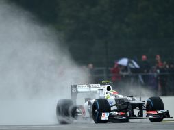 Sergio Pérez levanta una estela de agua en el circuito de Silverstone. AFP  /