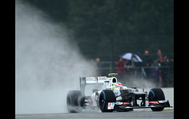 Sergio Pérez levanta una estela de agua en el circuito de Silverstone. AFP  /