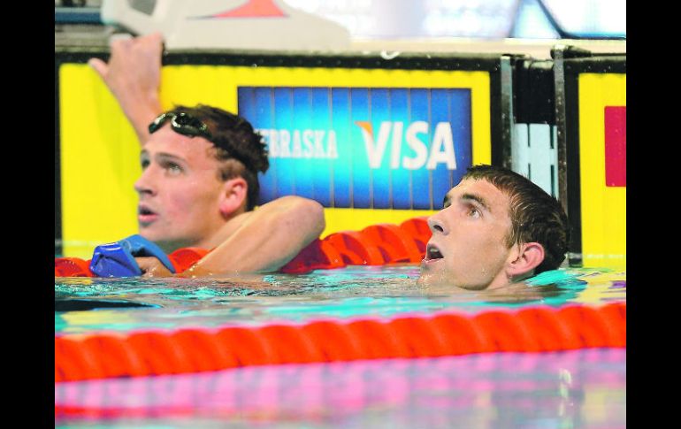 Amigos y rivales.  Ryan Lochte (izq.) y Michael Phelps observan la repetición durante los Selectivos de su país. AFP  /