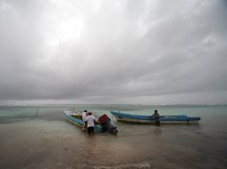 Pescadores de la comunidad de El Majahual, en Quintana Roo, protegen sus barcas en la zona donde impactará el huracán ''Ernesto''. EFE  /